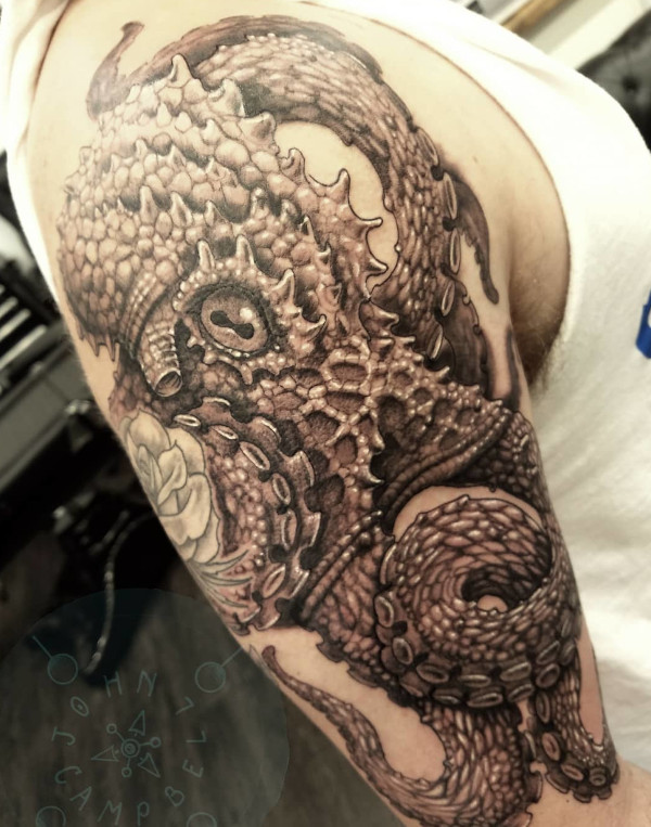Realistic detail work octopus upper arm black and grey tattoo by John Campbell at Sacred Mandala Studio tattoo parlor in Durham, NC.